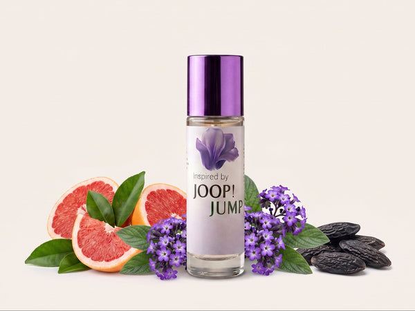 A clear cylindrical bottle with a metallic purple cap stands centered on a light beige background, surrounded by grapefruit slices, purple flowers, green leaves, and dark brown nuts. The bottle label reads 'Inspired by JOOP! JUMP' with a purple flower graphic.